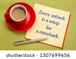 Every setback is a setup for a comeback - handwriting on a square note with a cup of coffee and pen