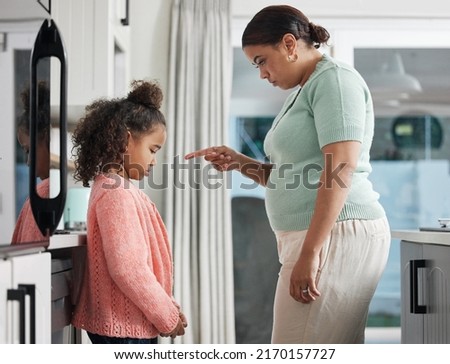 For every wrongdoing, theres an opportunity to learn. Shot of a little girl being spoken to sternly at home by her mother.