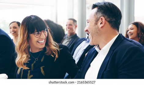 Everybody Loves A Good Ice Breaker. Shot Of A Group Of Businesspeople Laughing While Attending A Conference.