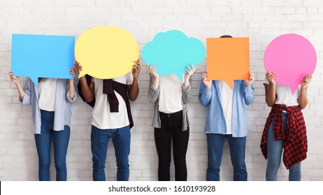 Everyone has own opinion. Teens holding empty colourful speech bubbles