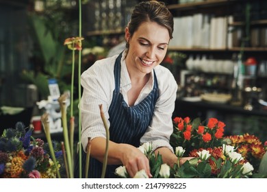 Everyone loves flowers. Cropped shot of an attractive young florist arranging flowers inside her plant nursery. - Powered by Shutterstock