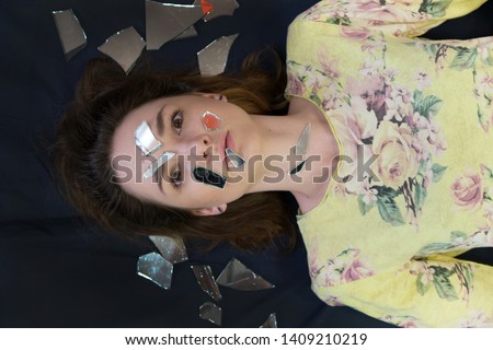 Everything is bad. I do not understand what is going on. Concept art photo of an unhappy scared woman unsatisfied with life dissatisfied brunette girl on a dark background. Made in a studio.