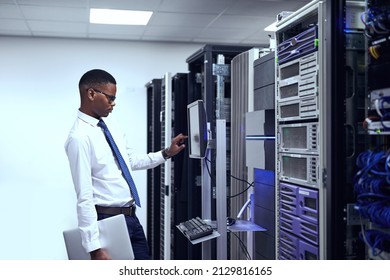 Everything seems to be in order. Cropped shot of a IT technician working and checking if all the servers are up and running. - Shutterstock ID 2129816165