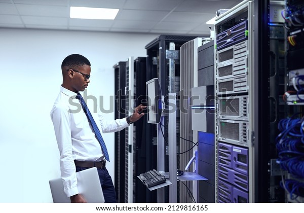 Everything seems to be in order. Cropped shot of
a IT technician working and checking if all the servers are up and
running.