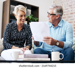 Everything You Need To Know Is In This Document. Shot Of A Senior Male Realtor Going Through Paperwork With A Client.