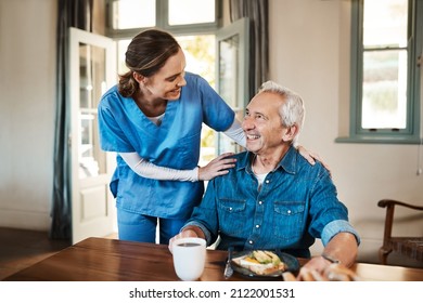 Everything to your satisfaction. Shot of a young nurse checking up on a senior man during breakfast at a nursing home. - Powered by Shutterstock