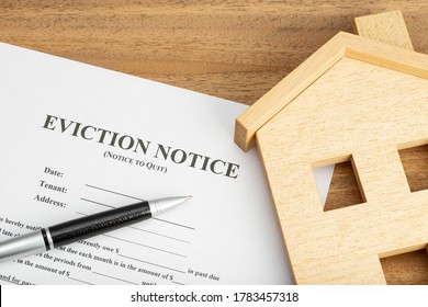 Eviction Notice Document and toy house on table - Shutterstock ID 1783457318