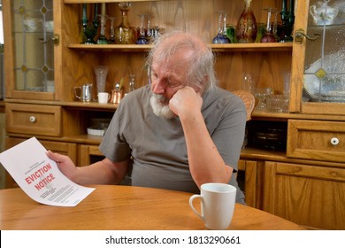 Eviction Notice   

Frustrated Old Man Sitting And Reading The Eviction Notice He Just Received.
  Old Veteran Being Evicted From His Home.
  