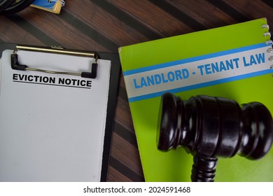 Eviction Notice Landlord - Tenant Law Write On A Paperwork Isolated On Wooden Table.