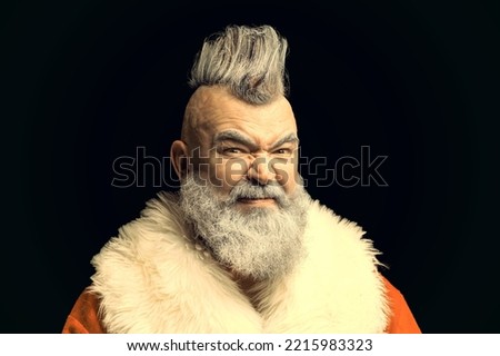 Evil aggressive gray-haired old man Santa in a bad mood. Severe dangerous Santa Claus with mohawk. New Year and Christmas in the company of an unusual bad Santa.