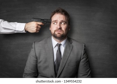 Evil Boss Holding A Gun On Businessman Head