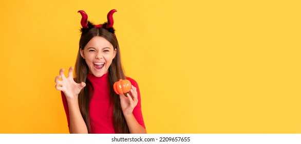 evil child in imp horns. happy halloween. devil kid with pumpkin. trick or treat. Halloween kid girl portrait, horizontal poster. Banner header with copy space. - Shutterstock ID 2209657655