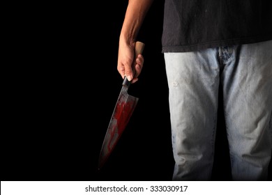 Evil criminal with large sharp knife ready for robbery or to commit a homicide isolated with clipping path inside