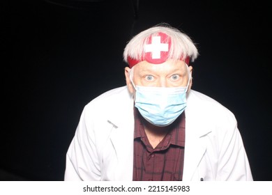 Evil Doctor. Halloween Costume. Halloween Photo Booth. Photo Booth. An Evil Doctor Poses As He Has His Photo Taken While In A Halloween Photo Booth With Black Velvet Curtains. Beware Of Bad Medicine. 