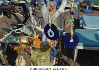 Evil eye bead with a painted and decorated tree - Powered by Shutterstock