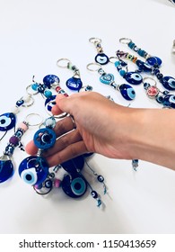 Evil Eye Stone, Lucky Amulet Souvenir From Turkey, Woman Choosing And Picking Key Chain