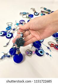 Evil Eye Stone, Lucky Amulet Souvenir From Turkey, Woman Choosing And Picking Key Chain