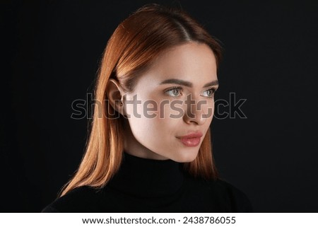 Evil eye. Young woman with scary eyes on black background