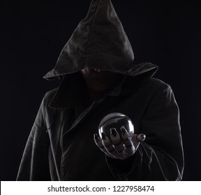 evil magician with a glass ball,sorcerer