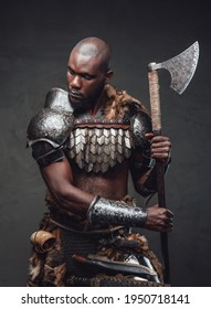Evil manly warrior wearing royal antique armor and wielding an axe