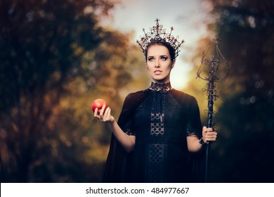 Evil Queen with Poisoned  Apple in Fantasy Portrait - Beautiful dark princess using black magic spell
