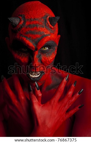 Evil red devil woman. Low key lighting.