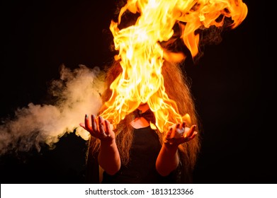 An Evil Red-haired Witch Holds Fire In Her Hands.