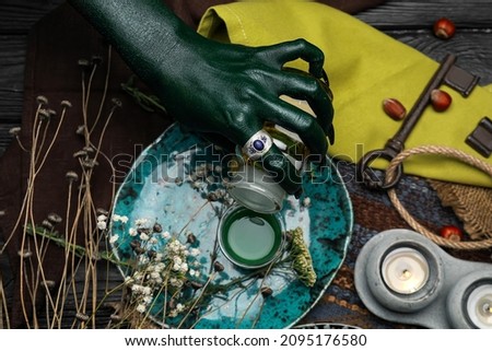 Evil witch making potion at table