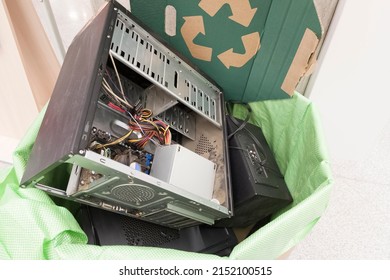 E-waste, electronics waste for reuse and recycle concept. Recycling bin full of old electronic devices in office building
