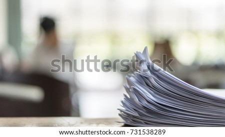 Exam answer sheet or application paper blurry view on table in examination room with blur education background of school university students taking exam test writing answer in seat row with stress