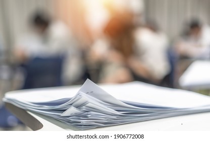 Exam Answer Sheet Pile, Blurry Application Document Paperwork Stack On Office Work Table In Examination Room Or Classroom With Blur Education Background School Class University Students Taking Test