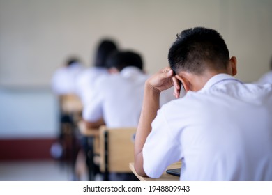 Exam Or Assessment Of Students Concept, Behind Student In Classroom Sitting On Chair, White Uniform Of School, Asain People In Test For Registration Test Of Knowledge