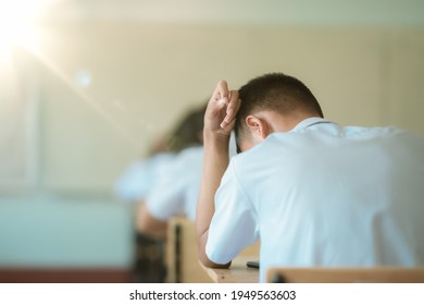 Exam Or Assessment Of Students Concept, Behind Student In Classroom Sitting On Chair, White Uniform Of School, Asain People In Test For Registration Test Of Knowledge