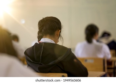 Exam Or Assessment Of Students Concept, Behind Student In Classroom Sitting On Chair, White Uniform Of School, Asain People In Test For Registration Test Of Knowledge