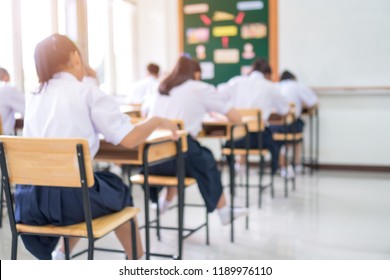 Exam For Education Uniform Students Testing Exams With Pencil For Multiple-choice Quizzes Or Test Answer Sheets Exercises In School Rows Chairs At Classroom In Thailand, Behind Asian Back To School