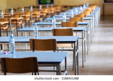 Exam examination room or hall set up ready for students to sit test. multiple desks tables and chairs. Education, school, student life concept. 