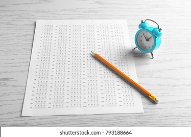 Exam Form, Pencil And Alarm Clock On Table