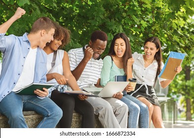 Exam Results. Group Of Joyful International Students Celebrating Success With Laptop Outdoors, Checking Their Test Scores Online