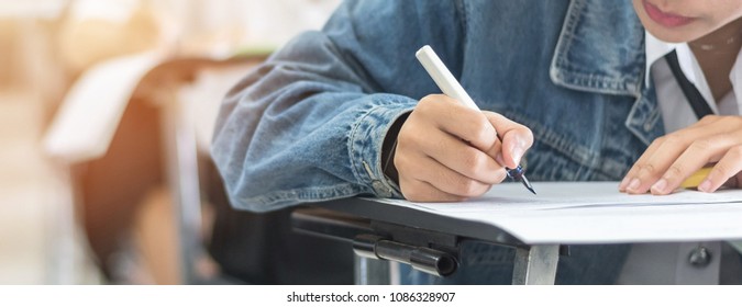 Exam With School Student Having A Educational Test, Thinking Hard, Writing Answer In Classroom For  University Education Admission And World Literacy Day Concept