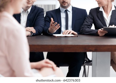 Examination Board Member In Suit Asking Question During Job Interview