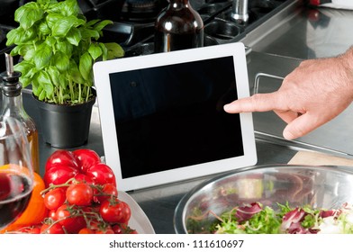 Examine digital recipe on tablet at kitchen to prepare the lunch - Powered by Shutterstock