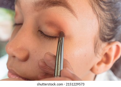 Example Of Eyeshadow Contouring On The Upper Eyelid Of A Young Asian Lady. Makeup Artist Techniques.