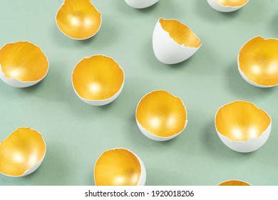 An Example Of Gold And Smoky Green Colors Combination. Eggshell Painted Inside With Gold Paint Isolated On Green. Modern Concept Of Festive Easter Advertising Banner Or Poster.
