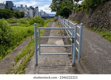 An example of a hyperart Thomasson, a useless structure, in this case a useless gate. Along the Saigawa river, Kanazawa, Japan.