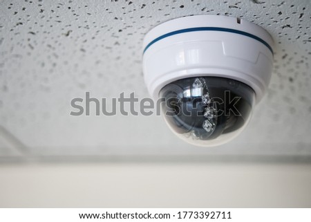                                An example of mounting a spherical surveillance video camera in a suspended ceiling of an office building. CCTV. Shallow depth of field