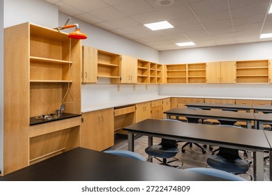 Example of a new empty nondescript US High School science classroom with desks, chairs, and white board. Classroom could be in almost any US High School. Nobody included in image.