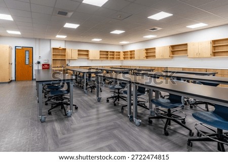Example of a new empty nondescript US High School science classroom with desks, chairs, and white board. Classroom could be in almost any US High School. Nobody included in image.
