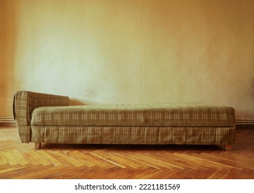 Example of Old Soviet Russian poor interior in Leningrad project House. Aged sofa, bed. Shabby floor. Tattered wallpaper on the wall. Apartment of pensioners. front view. - Shutterstock ID 2221181569