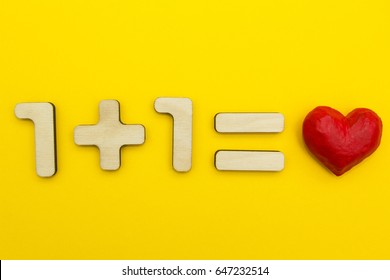 Example: One Plus One Equals Love On A Yellow Background.