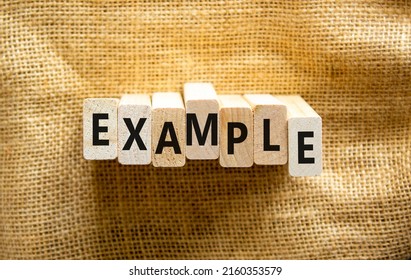 Example symbol. The concept word Example on wooden blocks. Beautiful canvas background, copy space. Business and example concept.